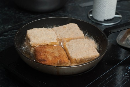 Frying Square Bread for Sandwich. Food Preparing pane in Pan with Oil. Food Ingredients.の写真素材