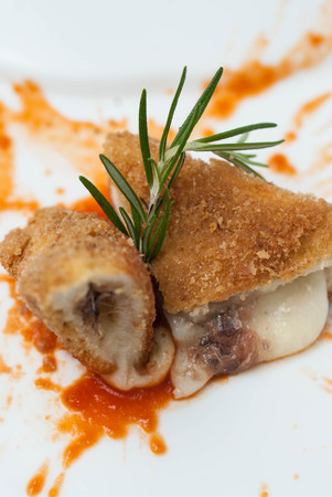 Pane Fish Meat. Fried Fish Meat with tomatoes Sauce on White Plate. Close up Food.の写真素材