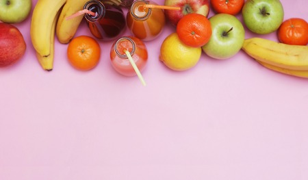 Fruit set on Pink background, bananas, Tangerine, Apples, Juice Bottle, space for textの写真素材