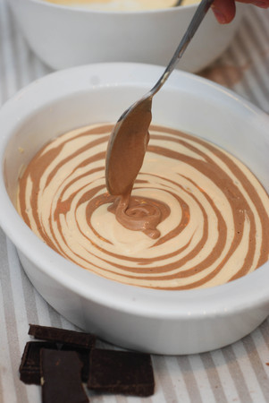 Mixing Liquid Chocolate and White Dough for Pancakes. Chocolate Dough for Pie. Top View.の写真素材
