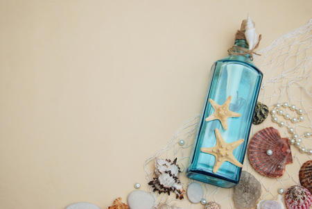 Nautical Theme Backdrop, Decorative Bottle with Shells, Starfish on Neutral Ivory Background. Place for text.の写真素材