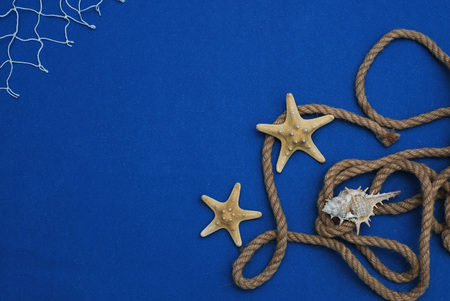 Starfish, Shell, Stones, Rope and Net Against a Blue Background. Summer Holliday. Nautical, Marrine conceptの写真素材