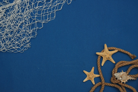 Starfish, Shell, Stones, Rope and Net Against a Blue Background. Summer Holliday. Nautical, Marrine conceptの写真素材