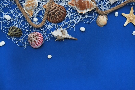 Starfish, Shell, Stones, Rope and Net Against a Blue Background. Summer Holliday. Nautical, Marrine conceptの写真素材