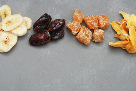 Mix of dried fruits and nuts on a dark wood background with copy space. Top view.の写真素材
