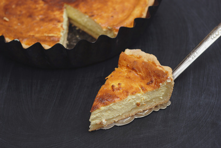 Homemade Delicious sweet Cottage Cheese, Vanilla Pie with cut out Slices on Black Slate.の写真素材