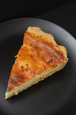 Homemade Delicious sweet Cottage Cheese, Vanilla Pie with cut out Slices on Black Slate. Isolated.の写真素材