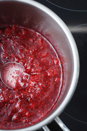 Fresh Summer Berries,, Healthy food. Thawing Process of Frozen Raspberries in the Saucepanの写真素材