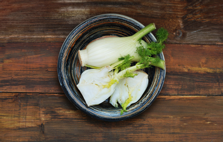Organic Fennel Bulbs with Salt and Pepper ready to cook over Wooden Background.の写真素材