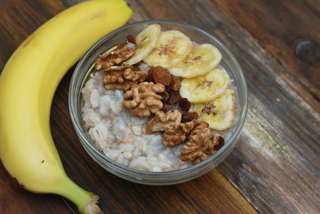 Top view of a Granola Bowl, Muesli with Oats, Nuts and Dried Fruit on Wooden table. Healthy Breakfast.の写真素材
