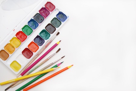 Top view of Work Process Blank Watercolor Paper pad, Watercolor Painting Supplies, Brushes and Colorful Pencil. Creation process of watercolor painting.の写真素材