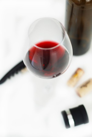 Glass of Red Wine Corkscrew Wine Bottle Corcks Isoalted on White Top viewの写真素材