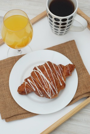 Croissant White Chocolate Breakfast Morning on white background. Cup of Tea or coffee. Rustic Style. Orange Juice.の写真素材