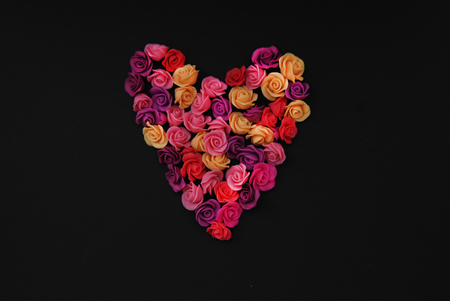 Mix of pink and Peach Fake Plastic Mini rosess Flowers Black Background copy space. Craft, Art,の写真素材