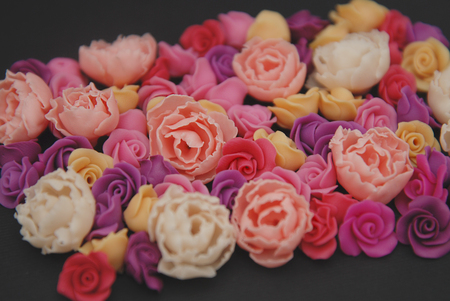 Mix of pink and Peach Fake Plastic Mini rosess Flowers Black Background copy space. Craft, Art,の写真素材