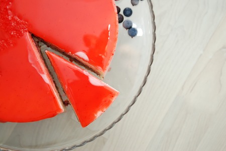 A Piece of Red Strawberry Cake covered with Mirror Red Glaze. Top Viewの写真素材