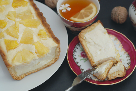 Pineapple Homemade Cheesecake Slice Piece Tea Cup Flowers Dark Backgroundの写真素材