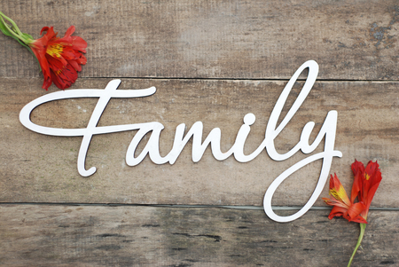 White Wooden Inscription FAMILY Letters Inscription Family of Wood on a Rustic Wooden background.の写真素材