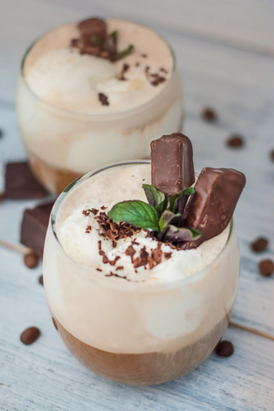 Iced Mocha Coffee with Whip Cream, Summer Drinking times. Coffee Beans. rustic textured Wooden Background.の写真素材