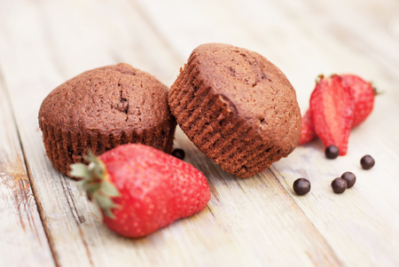 Chocolate Muffins with Strawberry Mint Leaves over rustic Gray Background Breakfastの写真素材