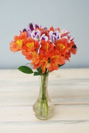 Spring Flowers Orange alstromeria flwoers in Glass Vase Wooden gift Bouquetの写真素材