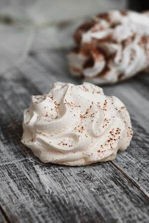 White Meringue Cookies. Sweet Desert over Gray rustic Wooden Boardの写真素材