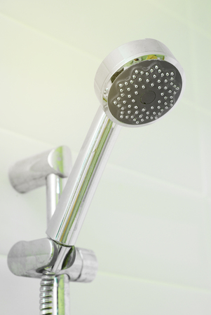 Close up Hanging Metal Shower on bathroom Wall. Personal Hygiene and Body Isoaltedの写真素材