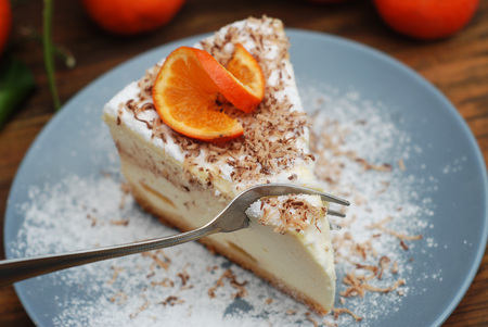 Tangerine citrus Cheescake Homemade on Gray Plate over Wooden Background. Top View. Dessert.の写真素材