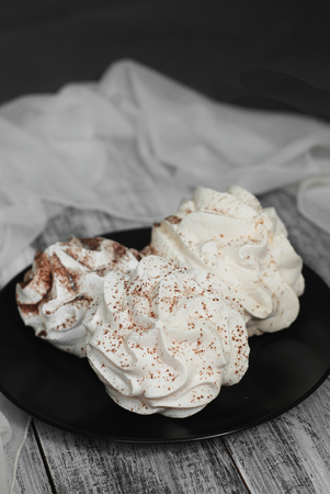White Meringue Cookies. Sweet Desert over Gray rustic Wooden Boardの写真素材