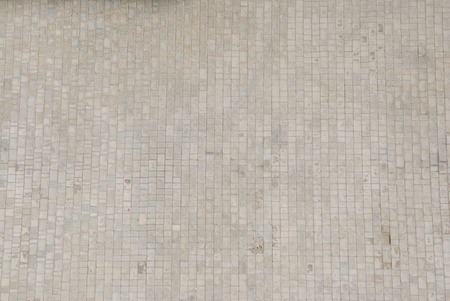 Close-up paving slabs by mosaic. Road paving, construction. Tessellated sidewalk tile. Gray paving slab.の写真素材