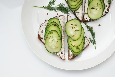 Fresh Vegan Sandwitches with Cucumber and Cheesecream over Gray Background