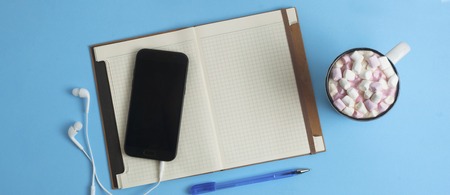 Work Space Mobile Phone, Notebook, Coffee Marshmellow Blue Background,の写真素材