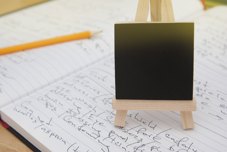 Still life wooden chalkboard label over raw cannelloni pasta as a backgroundの写真素材