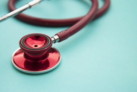 Medical red stethoscope isolated on blue background.の写真素材