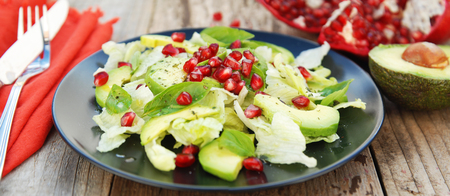 Vegetarian salad with avocado, greens, leaves, pomegranate and letuce leavesの写真素材