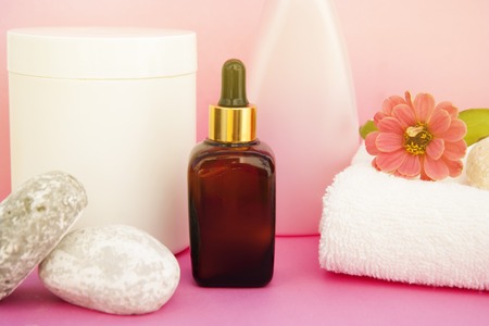 Beauty spa cosmetics, salon therapy concept. Glass cosmetic bottle on pink background.の写真素材