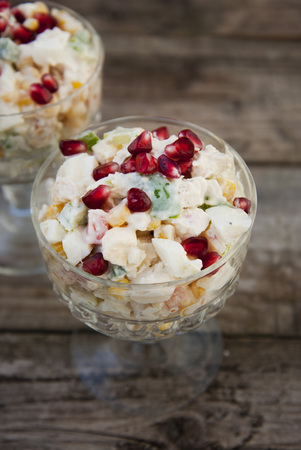 Traditional russian salad with mayonnaise on wooden table.の写真素材