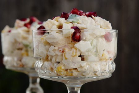 Traditional russian salad with mayonnaise on wooden table.の写真素材