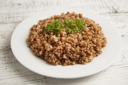 Cooked buckwheat on white wooden background.の写真素材
