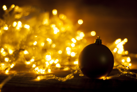 Abstract Christmas warm light celebration bokeh background with de focused lights and decorative bauble.の写真素材