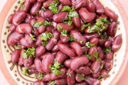 Cooked red beans plate on pink background, isolated.の写真素材