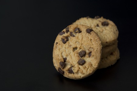 Chocolate cookies with hazelnuts and topping, isolated.