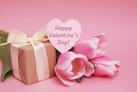 Colorful pink, fucsia Valentine's Day background greeting. Pink tulip flowers on pink background....