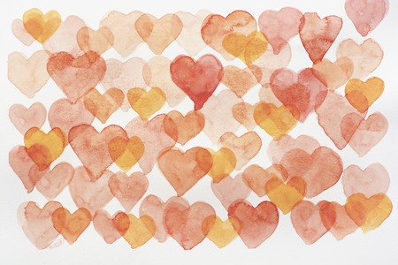 Seamless background with watercolor hearts in red, pink and burgundy colors on white backdropの写真素材