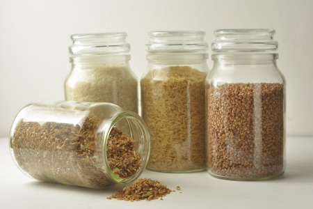 Various raw cereals, grains, rise, buckwheat and flakes. Healthy cooking in glass jars, white...