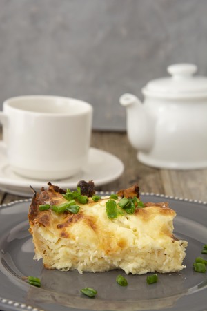 Cottage layered pie. Dough with cheese. Homemade pastry. Close up piece of pie.の写真素材