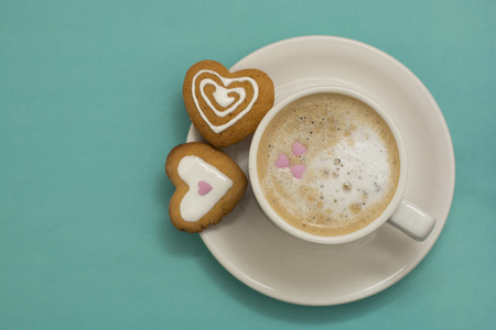 Cup of coffee or latte and heart shaped cookies, biscuits.の写真素材
