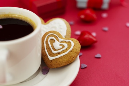 Close up heart shape ginger bread, cookie with cup of coffee, morning drink.の写真素材