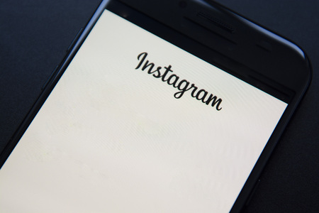 Corby, United Kingdom - January 27, 2019: Smartphone with Instagram application on the screen. Dark,...