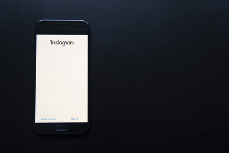 Corby, United Kingdom - January 27, 2019: Smartphone with Instagram application on the screen. Dark,...